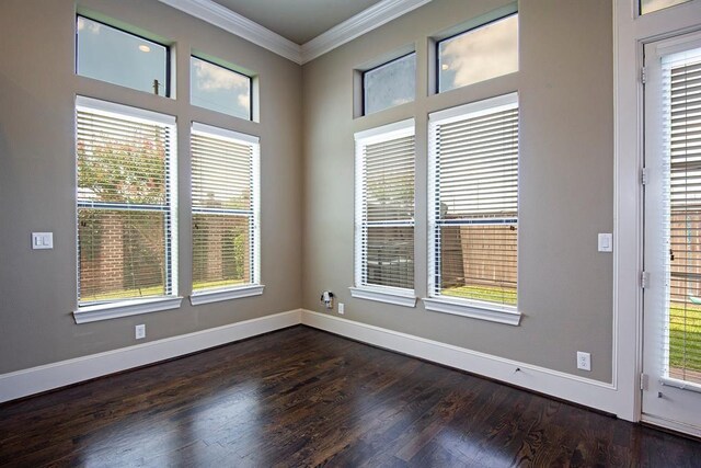 9948 Woodwind Ln N, Houston, TX 77025 - spare room featuring crown molding, baseboards, and dark wood-type flooring