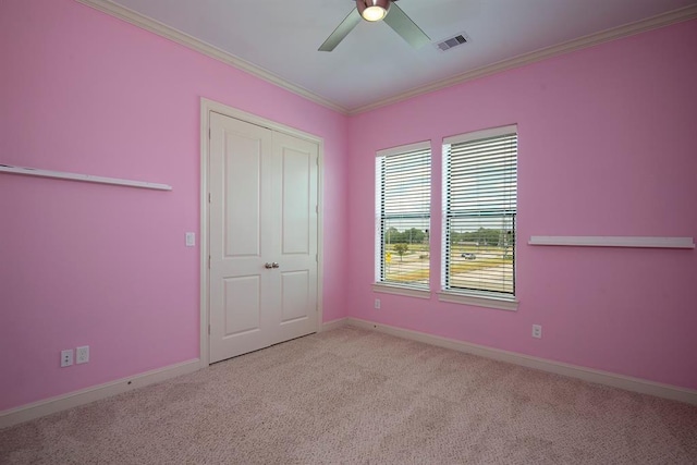 9948 Woodwind Ln N, Houston, TX 77025 - unfurnished bedroom featuring carpet flooring, ornamental molding, baseboards, ceiling fan, and a closet