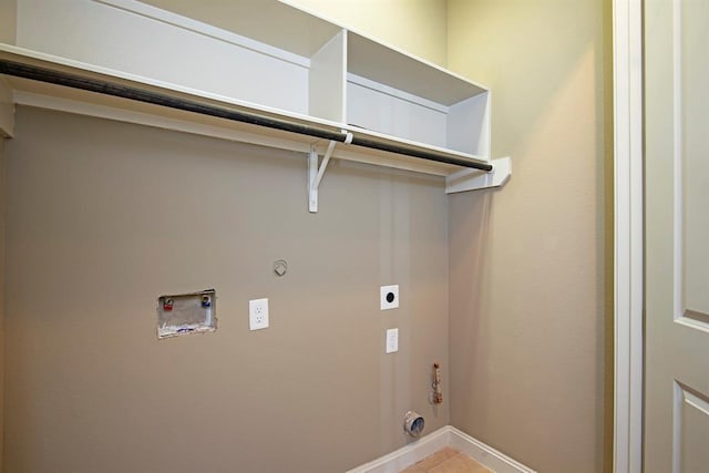 9948 Woodwind Ln N, Houston, TX 77025 - laundry area featuring gas dryer hookup, hookup for an electric dryer, hookup for a washing machine, baseboards, and light tile patterned floors