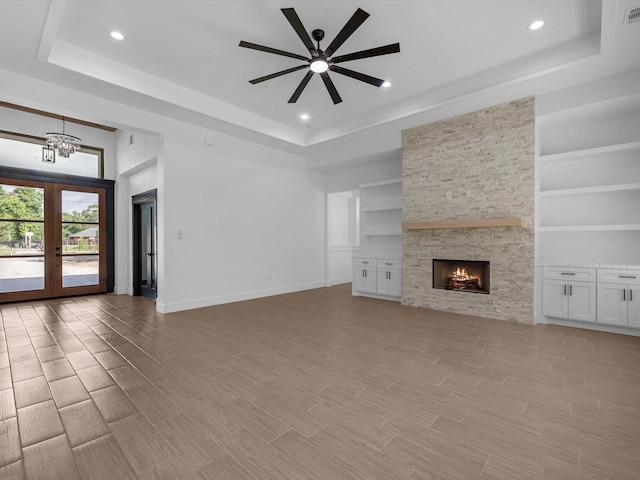 17107 Alara Dr, Splendora, TX 77372 - unfurnished living room with a raised ceiling, ceiling fan, a chandelier, and recessed lighting