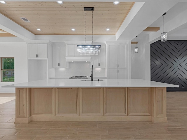 17107 Alara Dr, Splendora, TX 77372 - kitchen featuring a chandelier, a sink, light countertops, white cabinetry, and wooden ceiling