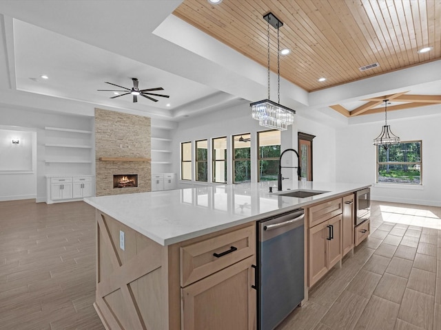 17107 Alara Dr, Splendora, TX 77372 - kitchen featuring stainless steel appliances, a tray ceiling, a sink, light brown cabinetry, and recessed lighting