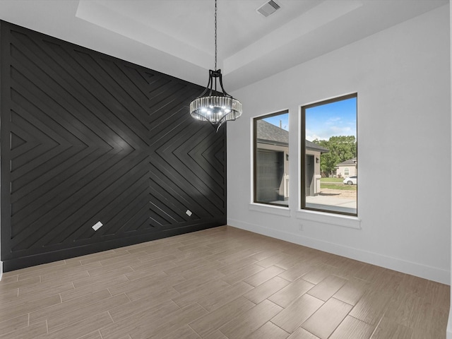 17107 Alara Dr, Splendora, TX 77372 - unfurnished room featuring a tray ceiling, baseboards, a chandelier, and light wood-type flooring