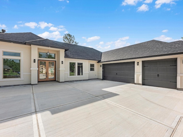 17107 Alara Dr, Splendora, TX 77372 - view of front of home with french doors, driveway, roof with shingles, an attached garage, and stucco siding