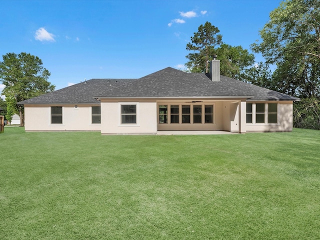 17107 Alara Dr, Splendora, TX 77372 - rear view of house featuring a chimney, a yard, a patio area, roof with shingles, and stucco siding