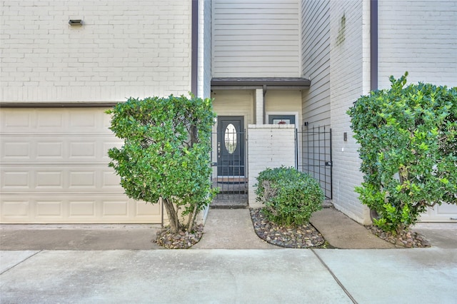 77 Chelsea Blvd, Houston, TX 77006 - view of exterior entry featuring brick siding, a gate, and an attached garage