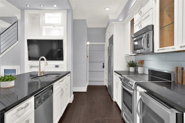 77 Chelsea Blvd, Houston, TX 77006 - kitchen featuring stainless steel appliances, a sink, white cabinets, dark stone countertops, and recessed lighting