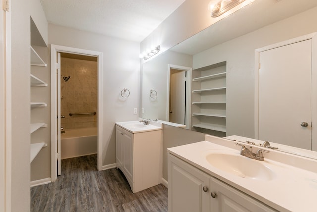 6930 Caddo Lake Ln, Houston, TX 77083 - full bath featuring two vanities, wood finished floors, and  shower combination
