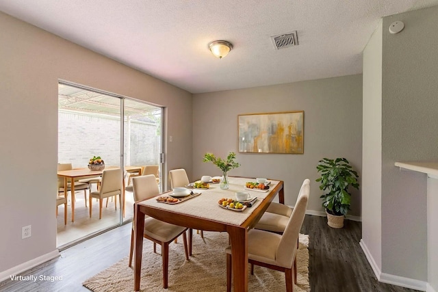 6930 Caddo Lake Ln, Houston, TX 77083 - dining space featuring wood finished floors and a textured ceiling