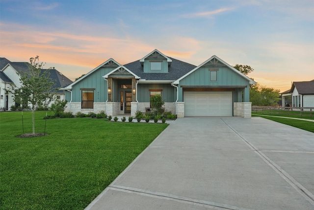4215 Wooded Isle Way, Fulshear, TX 77441 - craftsman-style house with board and batten siding, driveway, a yard, and stone siding