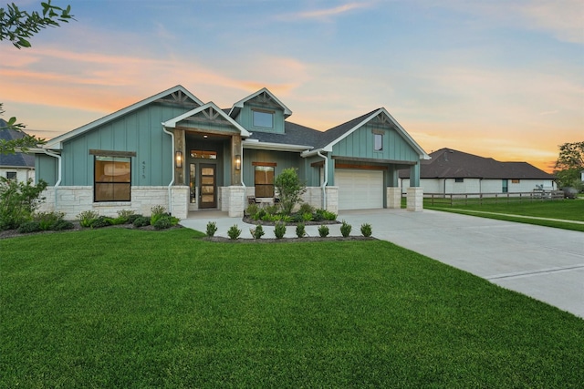4215 Wooded Isle Way, Fulshear, TX 77441 - view of front facade with board and batten siding, concrete driveway, stone siding, a front yard, and a garage