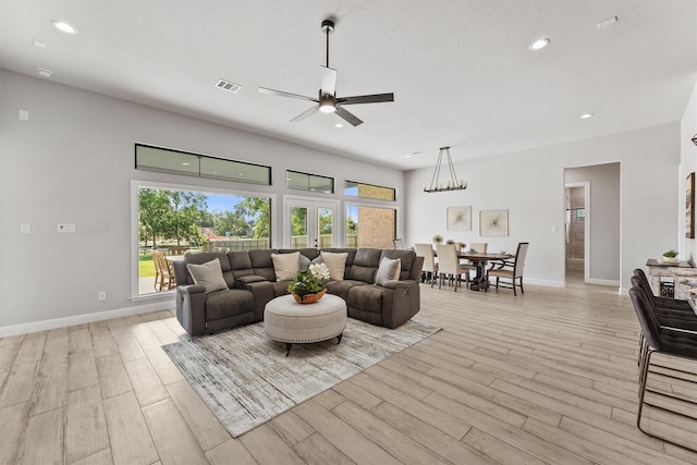 4215 Wooded Isle Way, Fulshear, TX 77441 - living area featuring light wood-type flooring, a ceiling fan, recessed lighting, and baseboards
