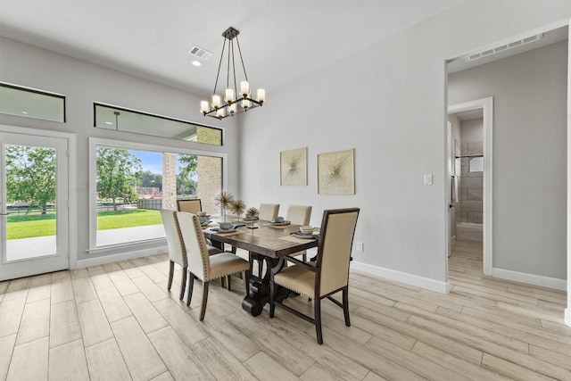 4215 Wooded Isle Way, Fulshear, TX 77441 - dining space featuring light wood-style floors, a chandelier, and baseboards