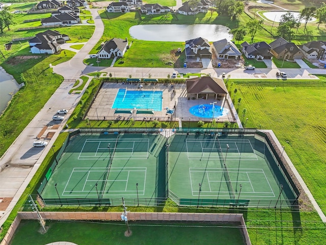 4215 Wooded Isle Way, Fulshear, TX 77441 - aerial perspective of suburban area featuring a pool and a large body of water