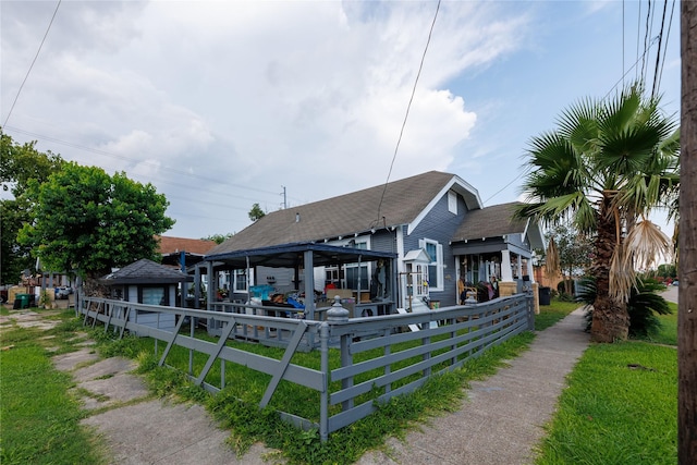 702 72nd St, Houston, TX 77011 - view of front of home with a shingled roof and a gazebo