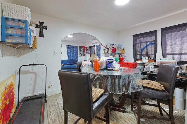 702 72nd St, Houston, TX 77011 - dining area featuring hardwood / wood-style flooring and arched walkways