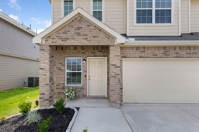 4438 Stephanie Park Ln, Conroe, TX 77304 - doorway to property featuring brick siding, an attached garage, and concrete driveway