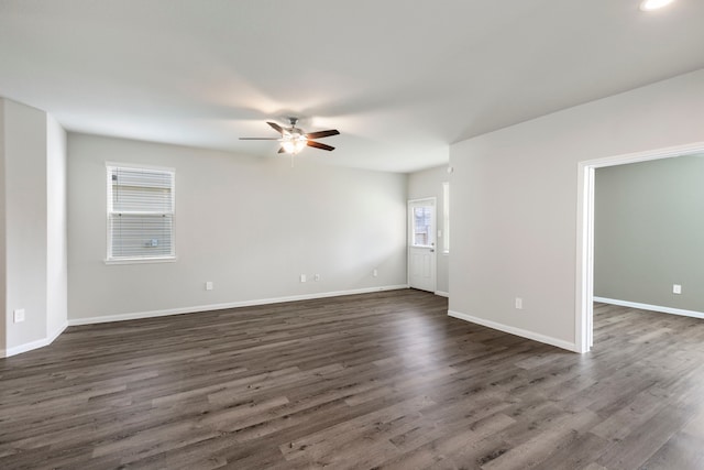 4438 Stephanie Park Ln, Conroe, TX 77304 - spare room featuring ceiling fan and dark wood-style floors