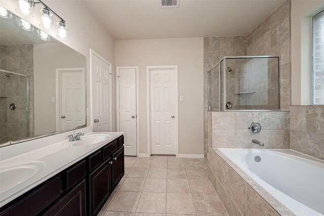 13322 Mesquite Stone Ln, Richmond, TX 77407 - bathroom featuring double vanity, a bath, a stall shower, and plenty of natural light