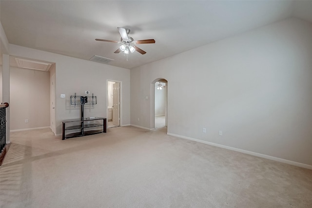 13322 Mesquite Stone Ln, Richmond, TX 77407 - unfurnished living room featuring attic access, light colored carpet, ceiling fan, arched walkways, and baseboards