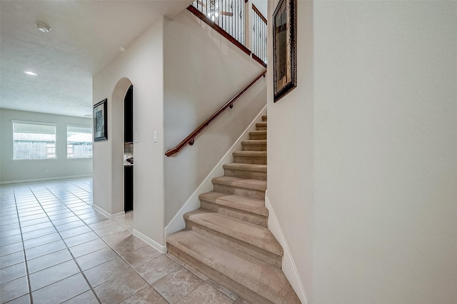 13322 Mesquite Stone Ln, Richmond, TX 77407 - stairway featuring baseboards, recessed lighting, and arched walkways