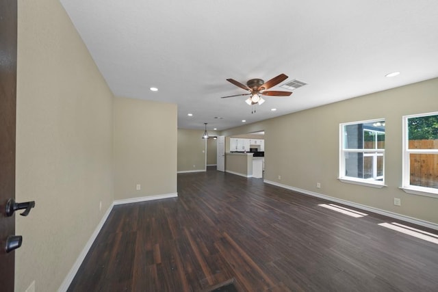 848 Nursery St, Clute, TX 77531 - unfurnished living room featuring dark wood-style floors, a ceiling fan, baseboards, and recessed lighting