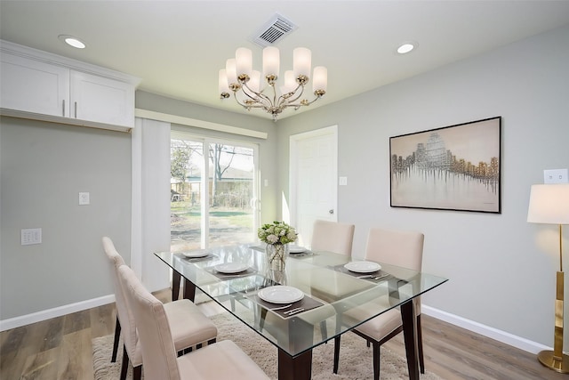 9510 Chesterfield Dr, Houston, TX 77051 - dining area featuring wood finished floors, a chandelier, baseboards, and recessed lighting