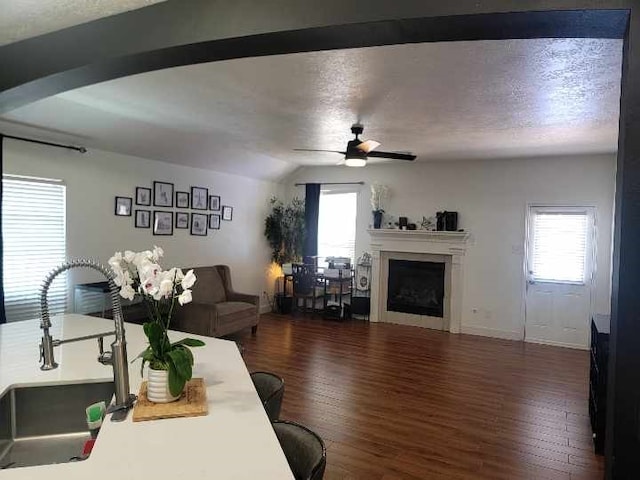 11411 Sugarbush Ridge Ln, Houston, TX 77089 - living area featuring ceiling fan, a fireplace, wood finished floors, lofted ceiling, and a textured ceiling