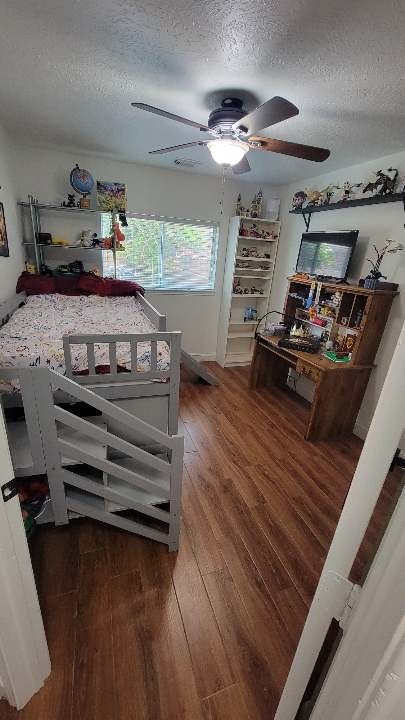 11411 Sugarbush Ridge Ln, Houston, TX 77089 - bedroom with a textured ceiling, wood finished floors, and ceiling fan