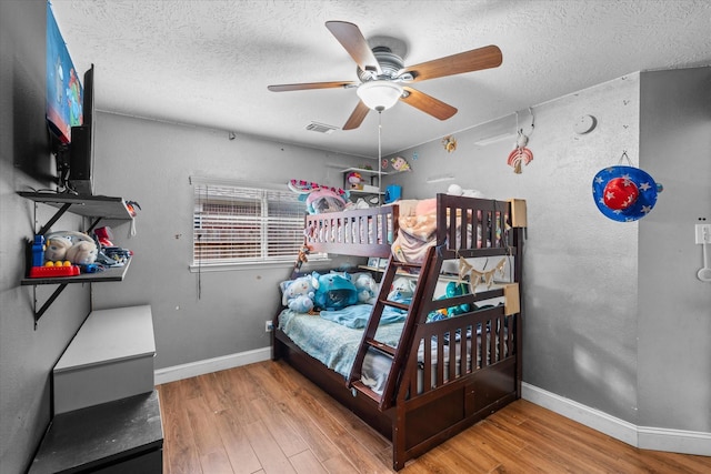 11411 Sugarbush Ridge Ln, Houston, TX 77089 - bedroom featuring wood finished floors, a textured ceiling, and ceiling fan