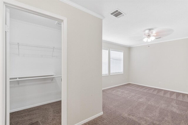21430 Cherry Canyon Ln, Tomball, TX 77375 - unfurnished bedroom with carpet flooring, a closet, baseboards, ornamental molding, and a walk in closet