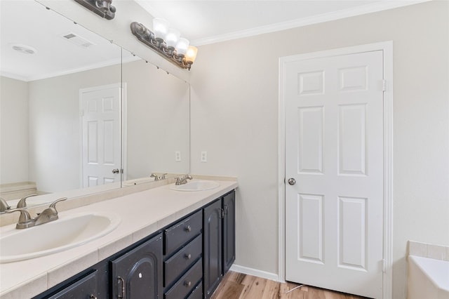 21430 Cherry Canyon Ln, Tomball, TX 77375 - bathroom featuring double vanity, wood finished floors, ornamental molding, a tub to relax in, and baseboards