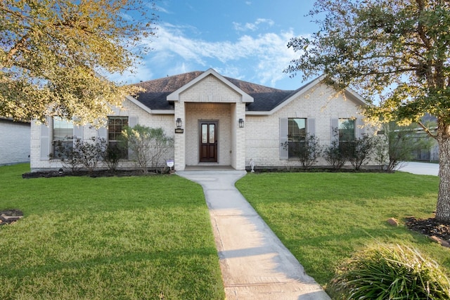 2119 Eagar Rd, League City, TX 77573 - view of front of house featuring a front lawn, brick siding, and a shingled roof