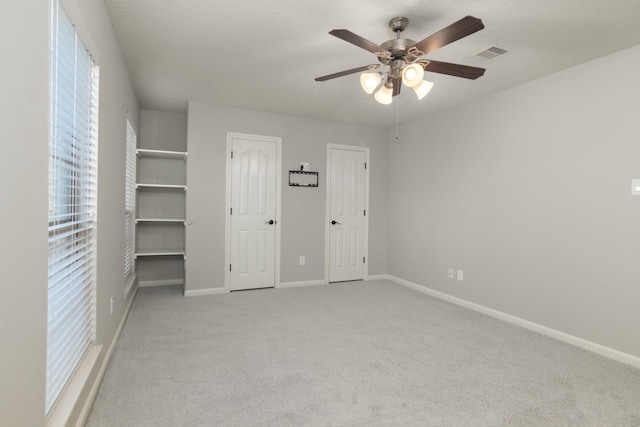 2119 Eagar Rd, League City, TX 77573 - unfurnished bedroom with carpet flooring, baseboards, a ceiling fan, and two closets