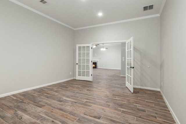 2119 Eagar Rd, League City, TX 77573 - empty room with french doors, ornamental molding, wood finished floors, baseboards, and ceiling fan