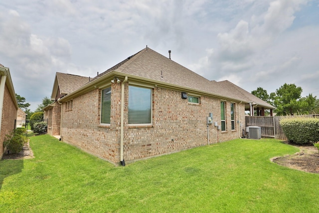 8823 Leaning Hollow Ln, Spring, TX 77379 - rear view of house with central AC, brick siding, and roof with shingles