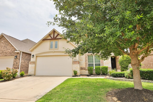8823 Leaning Hollow Ln, Spring, TX 77379 - view of front facade featuring concrete driveway, stucco siding, stone siding, and a front yard