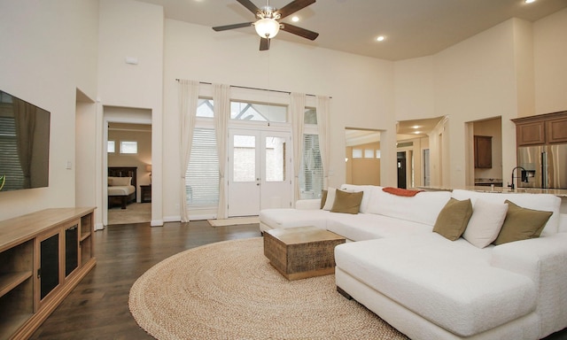 8823 Leaning Hollow Ln, Spring, TX 77379 - living area featuring a towering ceiling, ceiling fan, dark wood-style floors, and recessed lighting