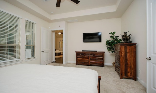 8823 Leaning Hollow Ln, Spring, TX 77379 - bedroom featuring a raised ceiling, light carpet, and a ceiling fan