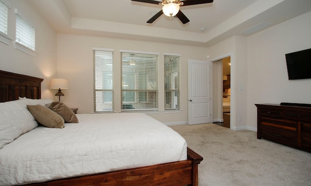 8823 Leaning Hollow Ln, Spring, TX 77379 - bedroom with carpet flooring, a tray ceiling, and ceiling fan