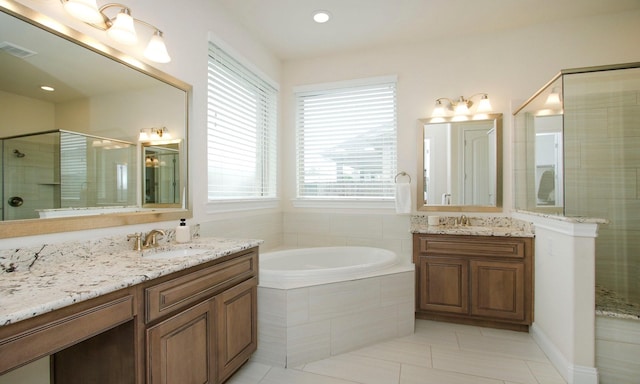 8823 Leaning Hollow Ln, Spring, TX 77379 - bathroom featuring tile patterned flooring, healthy amount of natural light, two vanities, and a bath