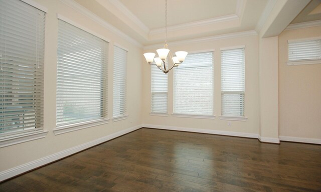 8823 Leaning Hollow Ln, Spring, TX 77379 - unfurnished dining area featuring a chandelier, a raised ceiling, dark wood finished floors, and ornamental molding