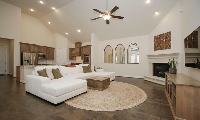 8823 Leaning Hollow Ln, Spring, TX 77379 - living area featuring high vaulted ceiling, recessed lighting, ceiling fan, a glass covered fireplace, and dark wood finished floors