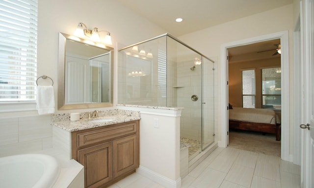 8823 Leaning Hollow Ln, Spring, TX 77379 - ensuite bathroom featuring a shower stall, a garden tub, vanity, and tile patterned flooring