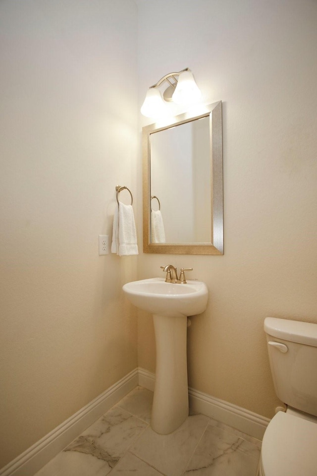 8823 Leaning Hollow Ln, Spring, TX 77379 - bathroom featuring marble look tiles and toilet