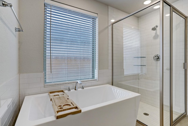 20923 Grand Surprise Ct, Cypress, TX 77433 - full bathroom featuring a shower stall, a freestanding bath, tile walls, and recessed lighting
