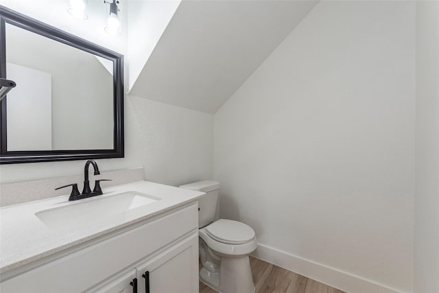 12034 Audubon Hill Ct, Houston, TX 77038 - half bath with wood finished floors, toilet, vanity, lofted ceiling, and baseboards