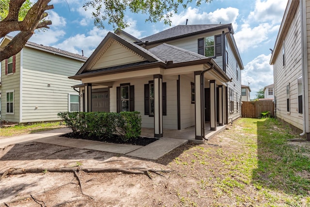 12034 Audubon Hill Ct, Houston, TX 77038 - view of front facade with covered porch, roof with shingles, and an attached garage