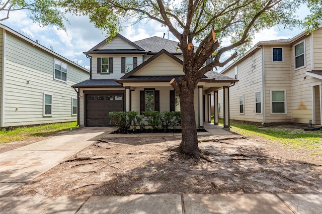 12034 Audubon Hill Ct, Houston, TX 77038 - view of front of home with driveway, a garage, covered porch, and a shingled roof