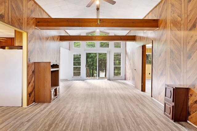 12 Walker Trl, Huntsville, TX 77320 - unfurnished living room featuring light wood-type flooring, ceiling fan, wood walls, and high vaulted ceiling